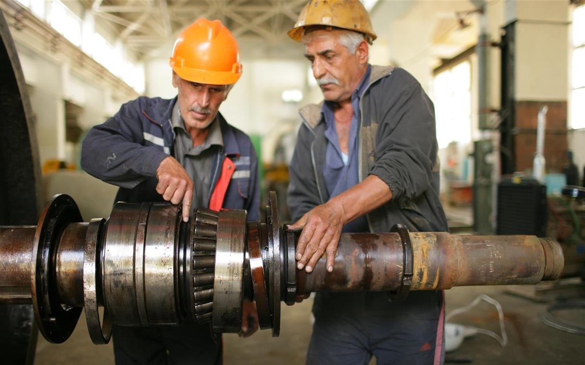 two men working on a machine
